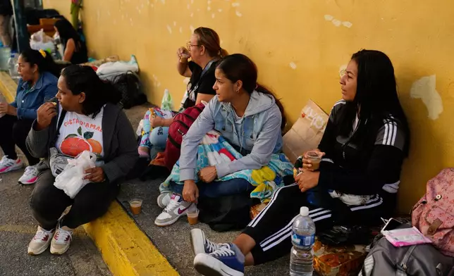 Relatives wait outside Zone 7 of the Bolivarian National Police, where political detainees are held, after spending the night there in Caracas, Venezuela, Monday, Jan. 12, 2026. (AP Photo/Ariana Cubillos)