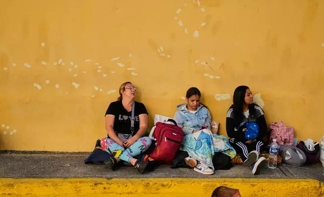 Relatives of political detainees wait outside Zone 7 of the Bolivarian National Police after spending the night there in Caracas, Venezuela, Monday, Jan. 12, 2026. (AP Photo/Ariana Cubillos)