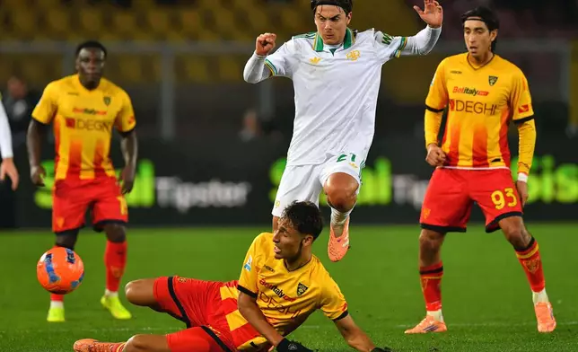 Lecce's Tiago Gabriel, botto, challenges Roma's Paulo Dybala during the Serie A soccer match between Lecce and Roma, in Lecce, Italy, Tuesday, Jan. 6, 2026. (Giovanni Evangelista/LaPresse via AP)