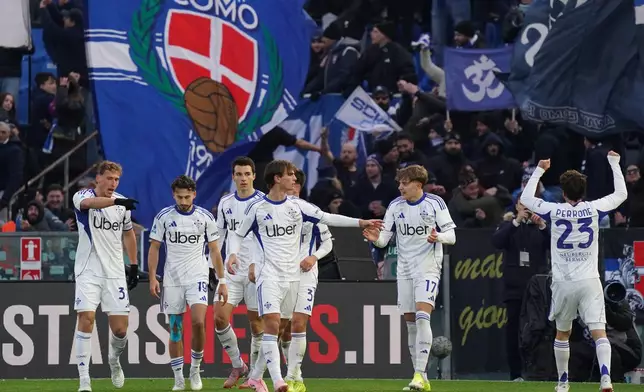 Como's Maximo Perrone, right, celebrates scoring his side's opening goal during the Serie A soccer match between Pisa and Como in Pisa, Italy, Tuesday Jan. 6, 2026 (Alessandro La Rocca/ LaPresse/LaPresse via AP)