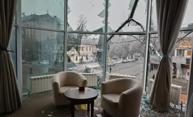 Broken window glass is seen in an apartment following a Russian air attack in the city center in Odesa, Ukraine, Tuesday, Jan. 27, 2026. (AP Photo/Michael Shtekel)