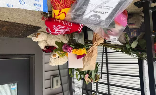 Flowers and other items sit on the front porch of Spencer and Monique Tepe's home in Columbus, Ohio, on Tuesday, Jan. 6, 2026. (AP Photo/Patrick Aftoora-Orsagos)