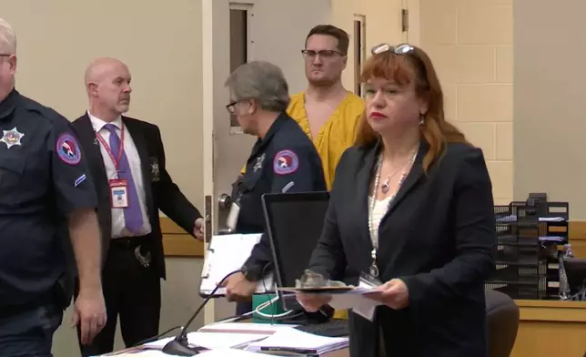 This image taken from video shows Michael David McKee walking into the courtroom on Monday, Jan. 12, 2026, in Rockford, Ill. (WIFR News/Pool Photo via AP)