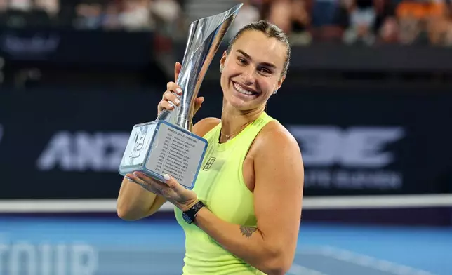 Aryna Sabalenka of Belarus poses with the winners trophy after winning the women's final match against Marta Kostyuk of Ukraine 6-4, 6-3, at the Brisbane International tennis tournament in Brisbane, Australia, Sunday, Jan. 11, 2026. (AP Photo/Tertius Pickard)