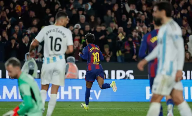 Barcelona's Lamine Yamal, center, celebrates after scoring his side's third goal during a Spanish La Liga soccer match between Barcelona and Real Oviedo in Barcelona, Spain, Sunday, Jan. 25, 2026. (AP Photo/Joan Monfort)