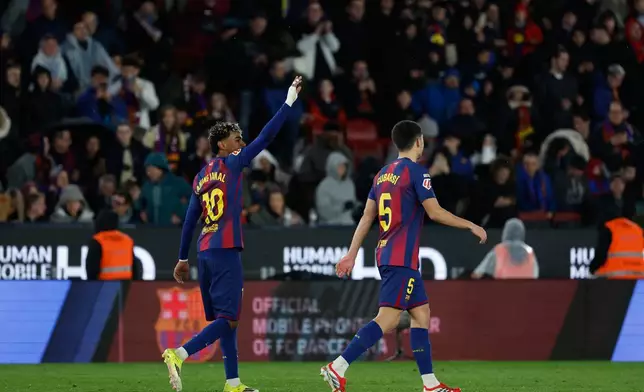 Barcelona's Lamine Yamal, left, celebrates after scoring his side's third goal during a Spanish La Liga soccer match between Barcelona and Real Oviedo in Barcelona, Spain, Sunday, Jan. 25, 2026. (AP Photo/Joan Monfort)