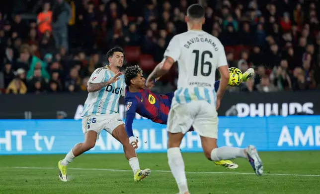 Barcelona's Lamine Yamal scores his side's third goal during a Spanish La Liga soccer match between Barcelona and Real Oviedo in Barcelona, Spain, Sunday, Jan. 25, 2026. (AP Photo/Joan Monfort)