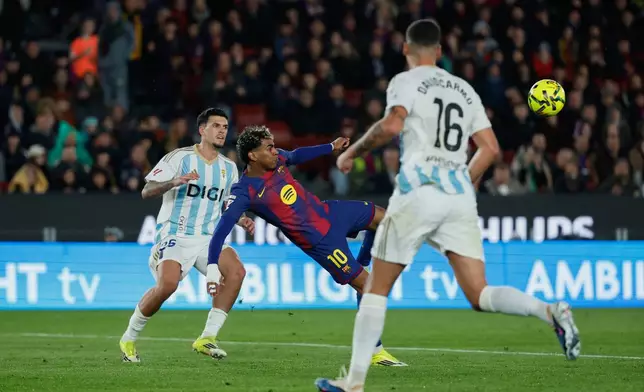 Barcelona's Lamine Yamal scores his side's third goal during a Spanish La Liga soccer match between Barcelona and Real Oviedo in Barcelona, Spain, Sunday, Jan. 25, 2026. (AP Photo/Joan Monfort)