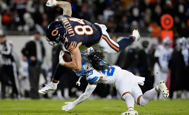 Chicago Bears tight end Colston Loveland (84) is tackled by Detroit Lions cornerback Avonte Maddox (29) during the second half of an NFL football game, Sunday, Jan. 4, 2026, in Chicago. (AP Photo/Nam Y. Huh)