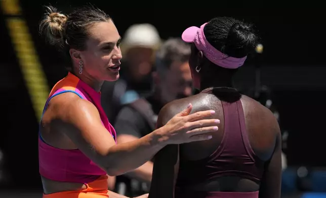 Aryna Sabalenka, left, of Belarus is congratulated by Victoria Mboko, right, of Canada following their fourth round match at the Australian Open tennis championship in Melbourne, Australia, Sunday, Jan. 25, 2026. (AP Photo/Dita Alangkara)