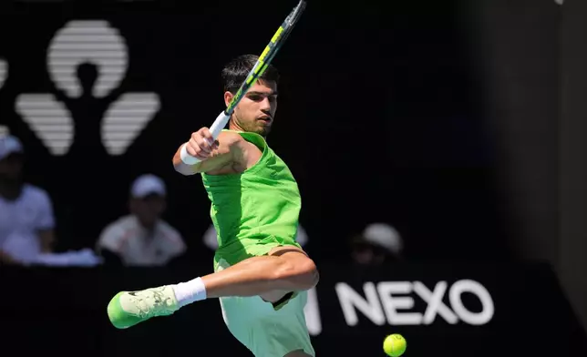 Carlos Alcaraz of Spain kicks the ball during his fourth round match against Tommy Paul of the U.S. at the Australian Open tennis championship in Melbourne, Australia, Sunday, Jan. 25, 2026. (AP Photo/Dita Alangkara)