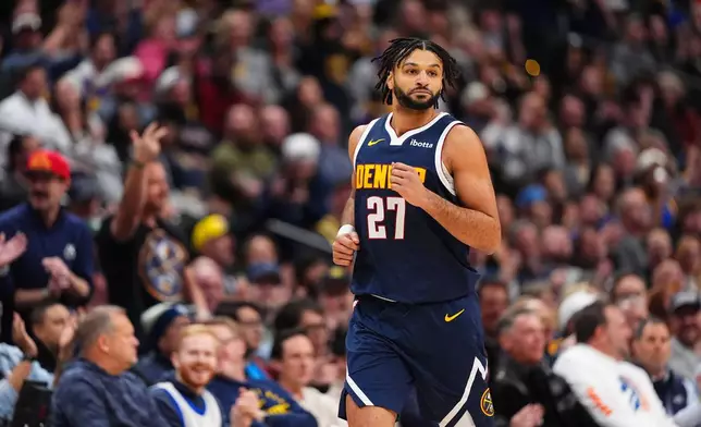 Denver Nuggets guard Jamal Murray celebrates a three point basket against the Los Angeles Lakers during the first half of an NBA basketball game Tuesday, Jan. 20, 2026, in Denver. (AP Photo/Jack Dempsey)