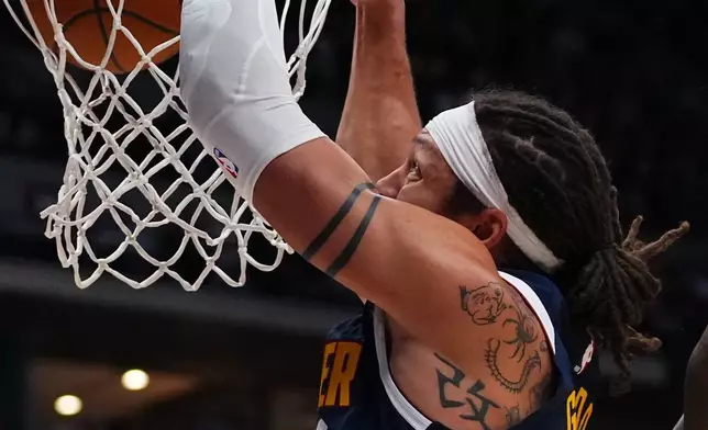 Denver Nuggets forward Aaron Gordon dunks against the Los Angeles Lakers during the second half of an NBA basketball game Tuesday, Jan. 20, 2026, in Denver. (AP Photo/Jack Dempsey)