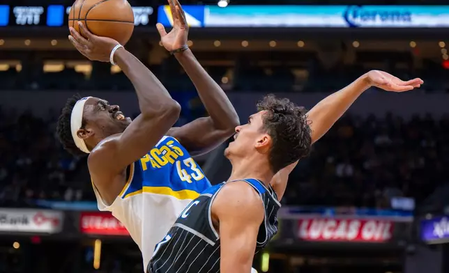 Indiana Pacers forward Pascal Siakam (43) shoots while being defended by Orlando Magic forward Tristan da Silva (23) during the first half of an NBA basketball game in Indianapolis, Wednesday, Dec. 31, 2025. (AP Photo/Doug McSchooler)