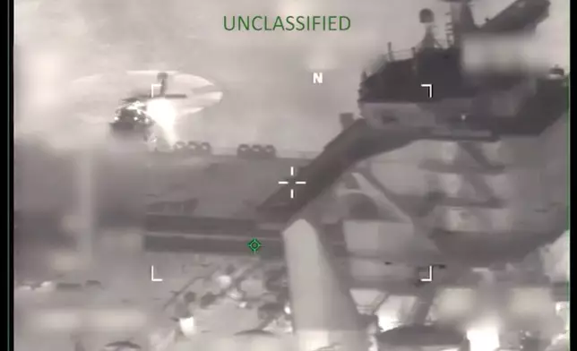 This image from video provided by the U.S. Department of Defense, shows U.S. forces boarding the M/T Sophia in the Caribbean Sea early Wednesday, Jan. 7, 2026. (Department of Defense via AP)