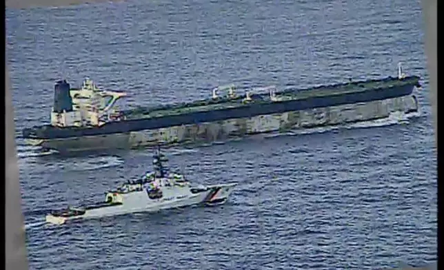 This image from video provided by the U.S. Department of Defense, shows the U.S. Coast Guard cutter Munro shadowing the MV Bella 1 in the North Atlantic Ocean during the maritime interdiction operation Wednesday, Jan. 7, 2026. (Department of Defense via AP)