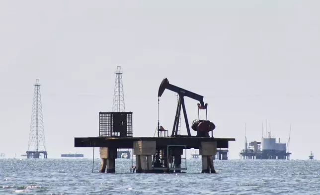 An oil pump jack stands unused in Cabimas, Venezuela, Wednesday, Jan. 7, 2026. (AP Photo/Edgar Frias)