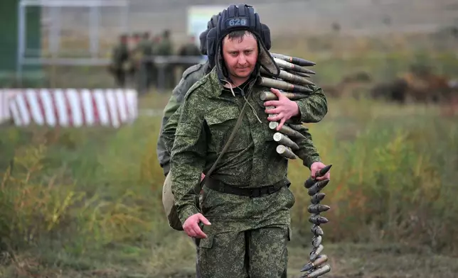 FILE- Recruits carry ammunition during training at a firing range in the Rostov-on-Don region of southern Russia, Tuesday, Oct. 4, 2022. (AP Photo, File)