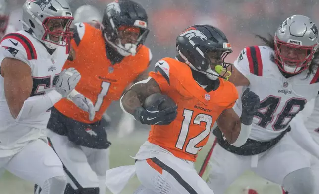 Denver Broncos running back RJ Harvey (12) runs as New England Patriots linebacker Jahlani Tavai (48) pursues during the second half of the AFC Championship NFL football game, Sunday, Jan. 25, 2026, in Denver. (AP Photo/Ashley Landis)