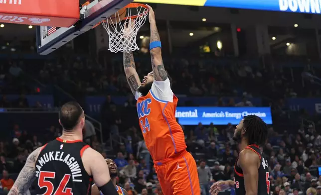 Oklahoma City Thunder guard Kenrich Williams (34) dunks between Toronto Raptors forward Sandro Mamukelashvili (54) and guard Immanuel Quickley, right, during the first half of an NBA basketball game Sunday, Jan. 25, 2026, in Oklahoma City. (AP Photo/Nate Billings)