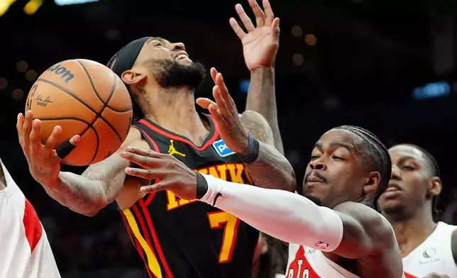 Atlanta Hawks guard Nickeil Alexander-Walker (7) is fouled on his way to the net by Toronto Raptors guard Jamal Shead, front right, during second-half NBA basketball game action in Toronto, Monday, Jan. 5, 2026. (Frank Gunn/The Canadian Press via AP)