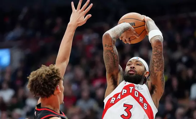 Atlanta Hawks guard Dyson Daniels, left, tries to stop Toronto Raptors forward Brandon Ingram (3) who looks to shoot during first-half NBA basketball game action in Toronto, Monday, Jan. 5, 2026. (Frank Gunn/The Canadian Press via AP)