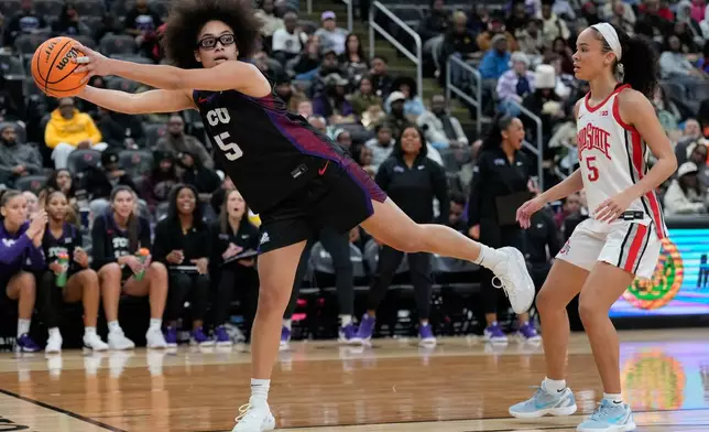 TCU's Olivia Miles, left, keeps the ball from going out-of-bounds while Ohio State's Ava Watson looks on during the first half of an NCAA women's college basketball game in Newark, N.J., Monday, Jan. 19, 2026. (AP Photo/Seth Wenig)