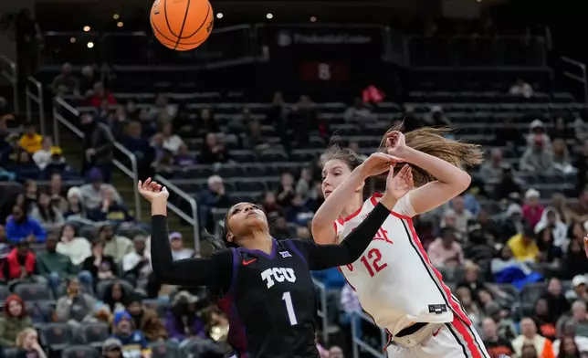 TCU's Taylor Bigby, left, and Ohio State's Elsa Lemmilä fight for the ball during the second half of an NCAA women's college basketball game in Newark, N.J., Monday, Jan. 19, 2026. (AP Photo/Seth Wenig)