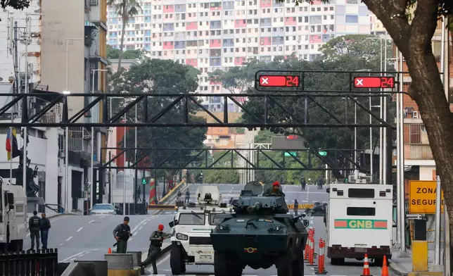 National Guard armored vehicles block an avenue leading to Miraflores presidential palace in Caracas, Venezuela, Saturday, Jan. 3, 2026. (AP Photo/Cristian Hernandez)