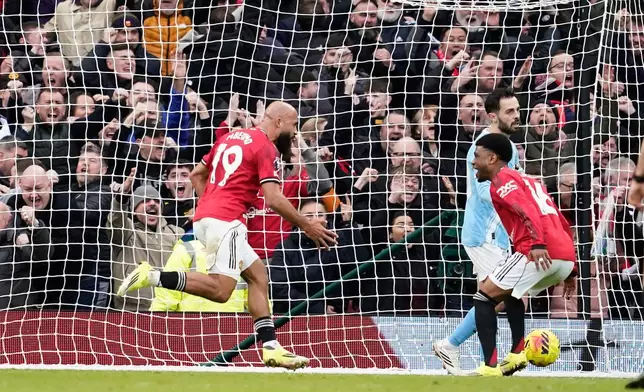 Manchester United's Bryan Mbeumo, left, celebrates after scoring his side's opening goal during the English Premier League soccer match between Manchester United and Manchester City in Manchester, England, Saturday, Jan. 17, 2026. (AP Photo/Dave Thompson)
