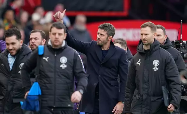 Manchester United's head coach Michael Carrick, centre, arrives ahead of the English Premier League soccer match between Manchester United and Manchester City in Manchester, England, Saturday, Jan. 17, 2026. (AP Photo/Dave Thompson)