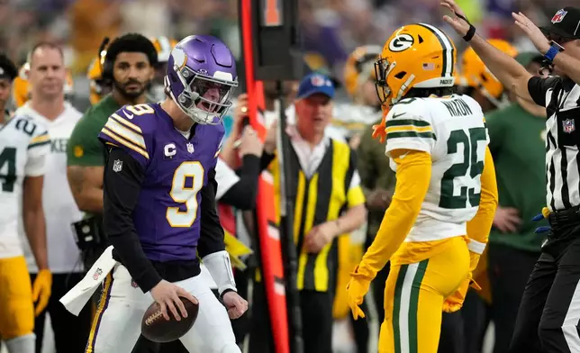 Minnesota Vikings quarterback J.J. McCarthy (9) reacts after getting tackled by Green Bay Packers cornerback Keisean Nixon (25) during the first half of an NFL football game, Sunday, Jan. 4, 2026, in Minneapolis. (AP Photo/Ross D. Franklin)