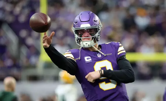 Minnesota Vikings quarterback J.J. McCarthy warms up before an NFL football game against the Green Bay Packers, Sunday, Jan. 4, 2026, in Minneapolis. (AP Photo/Ellen Schmidt)