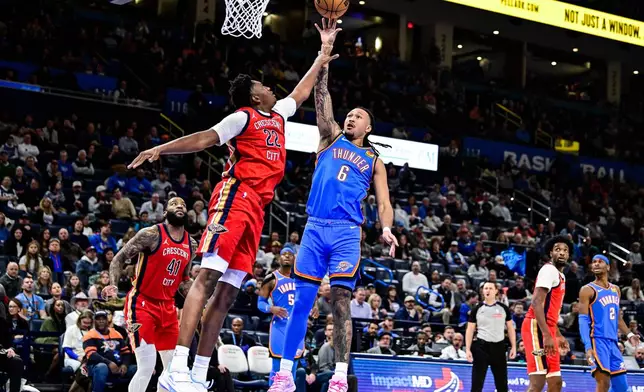 Oklahoma City Thunder forward Jaylin Williams (6) shoots against New Orleans Pelicans center Derik Queen (22) during the second half of an NBA basketball game Tuesday, Jan. 27, 2026, in Oklahoma City. (AP Photo/Gerald Leong)