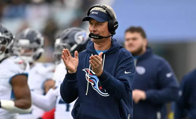 Tennessee Titans interim head coach Mike McCoy celebrates a touchdown during the first half of an NFL football game against the Jacksonville Jaguars, Sunday, Jan. 4, 2026, in Jacksonville, Fla. (AP Photo/Phelan M. Ebenhack)