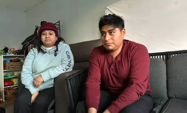 Angelica Fisher, left, and Cristian Vaca pose for a photo Thursday, Jan. 22, 2026, at his home in Biddeford, Maine. (AP Photo/Patrick Whittle)