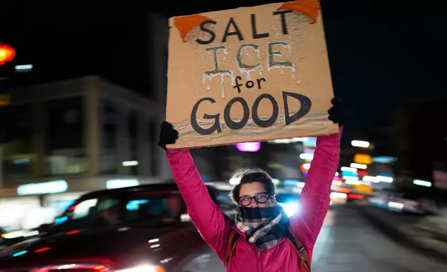 A protester rallies against the presence of U.S. Immigration Customs Enforcement in Maine, Friday, Jan. 23, 2026, in Portland, Maine. (AP Photo/Robert F. Bukaty)