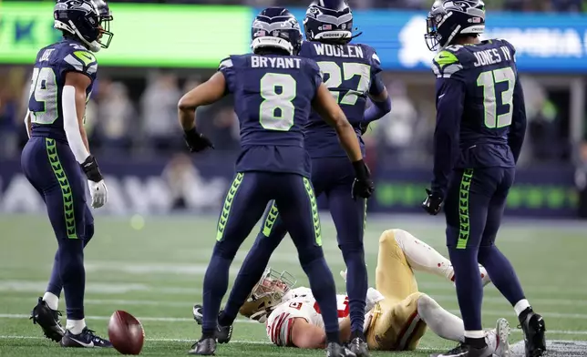 San Francisco 49ers' Christian McCaffrey reacts on the turf after being tackled by Seattle Seahawks' defense during an NFL football divisional playoff game Saturday, Jan. 17, 2026, in Seattle. (Scott Strazzante/San Francisco Chronicle via AP)