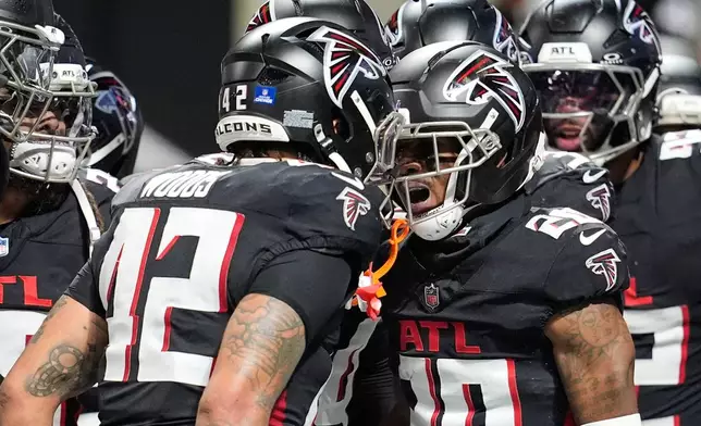 Atlanta Falcons cornerback Dee Alford (20) celebrates his interception with linebacker Josh Woods (42) in the second half of an NFL football game against the New Orleans Saints, Sunday, Jan. 4, 2026, in Atlanta. (AP Photo/Mike Stewart)