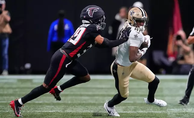 New Orleans Saints wide receiver Kevin Austin Jr. (81) carries against Atlanta Falcons cornerback C.J. Henderson (39) in the first half of an NFL football game, Sunday, Jan. 4, 2026, in Atlanta. (AP Photo/Brynn Anderson)