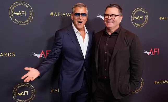 Actors George Clooney, left, and Nick Offerman pose together at the AFI Awards at the Four Seasons in Los Angeles, Friday, Jan. 9, 2026. (AP Photo/Chris Pizzello)