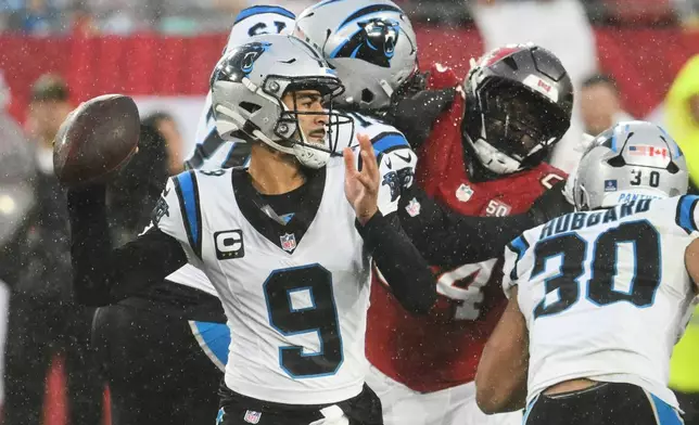 Carolina Panthers quarterback Bryce Young (9) throws under pressure during the first half of an NFL football game against the Tampa Bay Buccaneers Saturday, Jan. 3, 2026, in Tampa, Fla. (AP Photo/Jason Behnken)