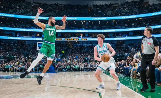 Charlotte Hornets guard Kon Knueppel looks to shoot the ball against Dallas Mavericks forward Caleb Martin (16) during an NBA basketball game, Thursday, Jan. 29, 2026, in Dallas. (AP Photo/Jessica Tobias)