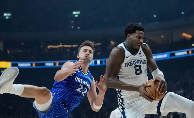 Orlando Magic forward Franz Wagner (22) and Memphis Grizzlies forward Jaren Jackson Jr. (8) challenge for the ball during an NBA basketball game between Orlando Magic and Memphis Grizzlies in Berlin, Germany, Thursday, Jan. 15, 2026. (AP Photo/Ebrahim Noroozi)