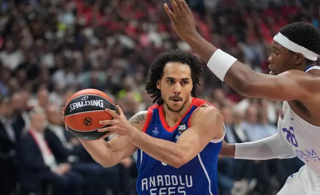Anadolu Efes' Shane Larkin in action by Real Madrid's Guerschon Yabusele during Final Four Euroleague finall basketball match between Anadolu Efes and Real Madrid, in Belgrade, Serbia, Saturday, May 21, 2022. (AP Photo/Darko Vojinovic)