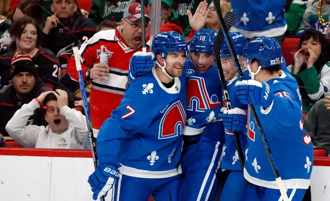 Colorado Avalanche teammates celebrate after a goal by Jack Drury (18) during the third period of an NHL hockey game against the Carolina Hurricanes in Raleigh, N.C., Saturday, Jan. 3, 2026. (AP Photo/Karl DeBlaker)