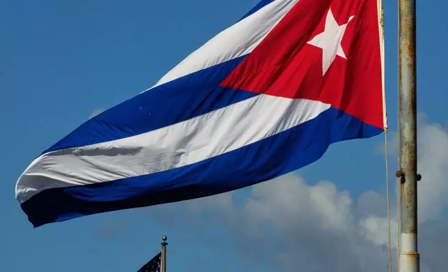 The Cuban flag flies at half-mast at the Anti-Imperialist Tribune near the U.S. embassy in Havana, Cuba, Monday, Jan. 5, 2026, in memory of Cubans who died two days before in Caracas, Venezuela during the capture of Venezuelan President Nicolas Maduro by U.S. forces. (AP Photo/Ramon Espinosa)