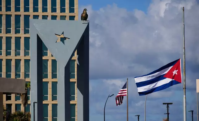 The Cuban flag flies at half-mast at the Anti-Imperialist Tribune near the U.S. embassy in Havana, Cuba, Monday, Jan. 5, 2026, in memory of Cubans who died two days before in Caracas, Venezuela during the capture of Venezuelan President Nicolas Maduro by U.S. forces. (AP Photo/Ramon Espinosa)