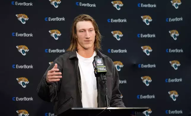Jacksonville Jaguars quarterback Trevor Lawrence talks to reporters following an NFL wild-card playoff football game against the Buffalo Bills Sunday, Jan. 11, 2026, in Jacksonville, Fla. (AP Photo/John Raoux)