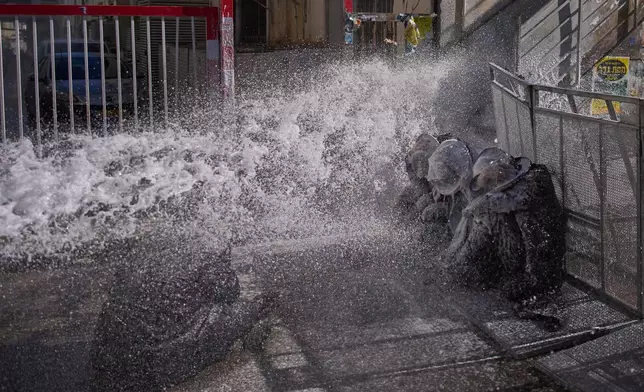 FILE - Police use water cannon to disperse ultra-Orthodox Jewish men blocking a street during a protest against army draft in Jerusalem, Israel, Sunday, Jan. 4, 2026. (AP Photo/Ohad Zwigenberg, File)